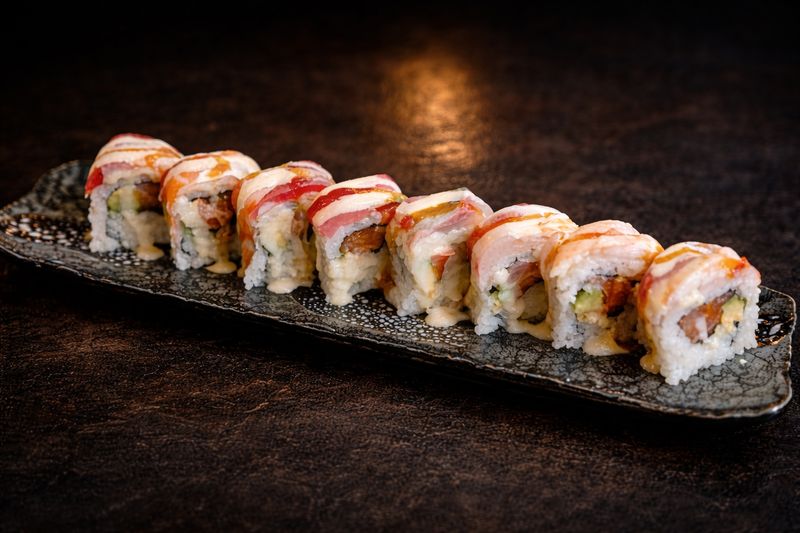 A salmon-topped sushi roll