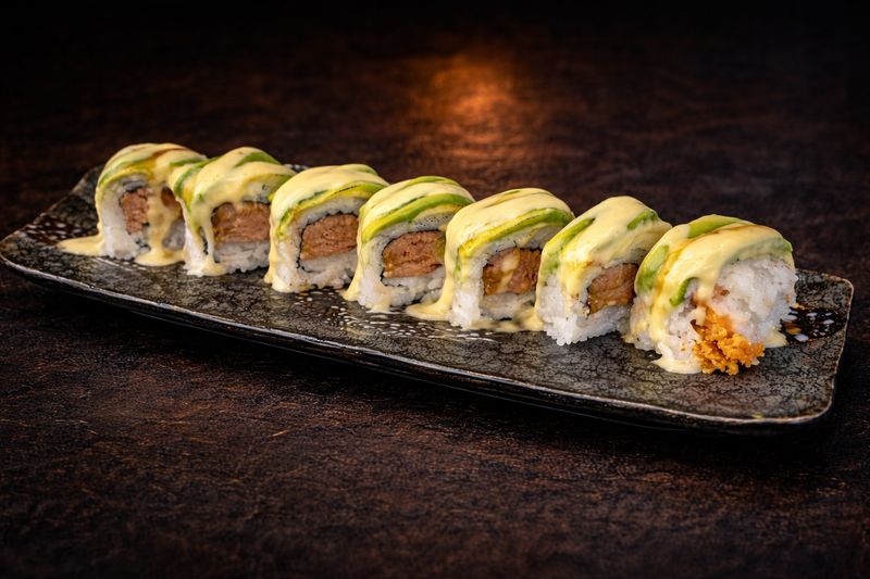 An avocado-topped sushi roll